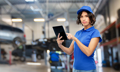 Image showing female worker with tablet pc at car service