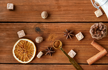 Image showing spices, brown sugar and milk on wooden background