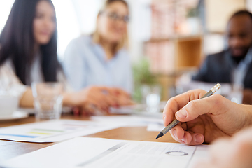 Image showing Close up hands of co-workers having casual discussion in office. Executives during friendly discussion, month reporting, creative meeting