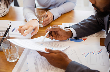 Image showing Close up hands of co-workers having casual discussion in office. Executives during friendly discussion, month reporting, creative meeting