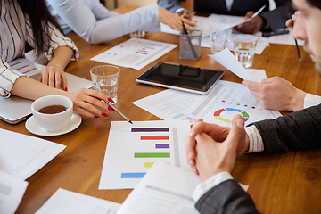 Image showing Close up hands of co-workers having casual discussion in office. Executives during friendly discussion, month reporting, creative meeting