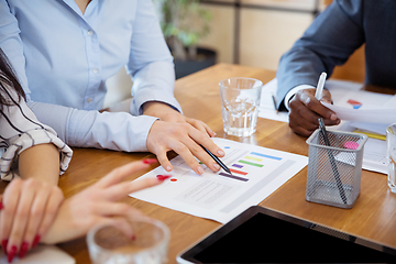 Image showing Close up hands of co-workers having casual discussion in office. Executives during friendly discussion, month reporting, creative meeting