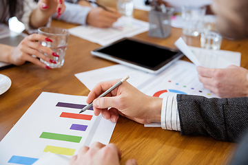 Image showing Close up hands of co-workers having casual discussion in office. Executives during friendly discussion, month reporting, creative meeting