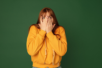 Image showing Caucasian woman\'s portrait isolated on green studio background with copyspace