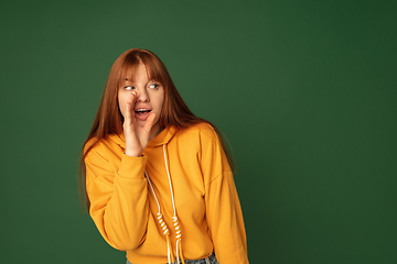 Image showing Caucasian woman\'s portrait isolated on green studio background with copyspace