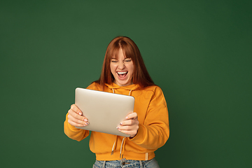 Image showing Caucasian woman\'s portrait isolated on green studio background with copyspace