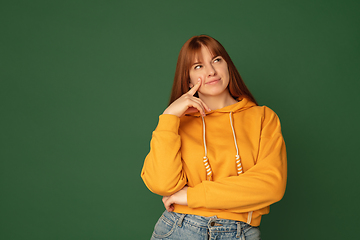 Image showing Caucasian woman\'s portrait isolated on green studio background with copyspace