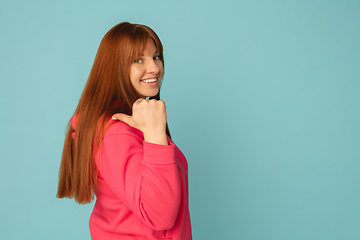 Image showing Caucasian woman\'s portrait isolated on blue studio background with copyspace