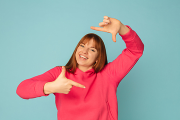 Image showing Caucasian woman\'s portrait isolated on blue studio background with copyspace