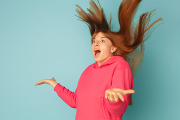 Image showing Caucasian woman\'s portrait isolated on blue studio background with copyspace