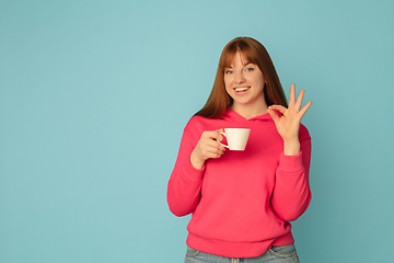 Image showing Caucasian woman\'s portrait isolated on blue studio background with copyspace