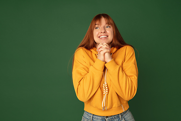 Image showing Caucasian woman\'s portrait isolated on green studio background with copyspace