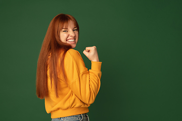 Image showing Caucasian woman\'s portrait isolated on green studio background with copyspace