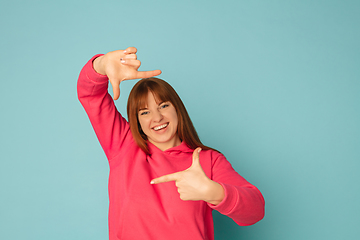 Image showing Caucasian woman\'s portrait isolated on blue studio background with copyspace