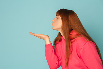 Image showing Caucasian woman\'s portrait isolated on blue studio background with copyspace