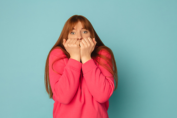 Image showing Caucasian woman\'s portrait isolated on blue studio background with copyspace