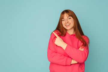 Image showing Caucasian woman\'s portrait isolated on blue studio background with copyspace