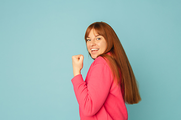 Image showing Caucasian woman\'s portrait isolated on blue studio background with copyspace