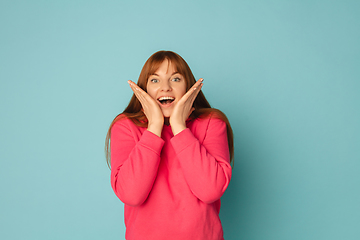 Image showing Caucasian woman\'s portrait isolated on blue studio background with copyspace