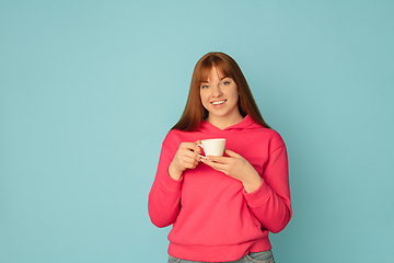 Image showing Caucasian woman\'s portrait isolated on blue studio background with copyspace