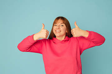 Image showing Caucasian woman\'s portrait isolated on blue studio background with copyspace