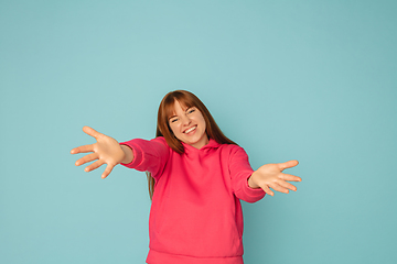 Image showing Caucasian woman\'s portrait isolated on blue studio background with copyspace