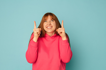 Image showing Caucasian woman\'s portrait isolated on blue studio background with copyspace