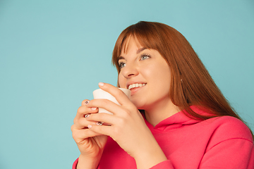 Image showing Caucasian woman\'s portrait isolated on blue studio background with copyspace