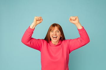 Image showing Caucasian woman\'s portrait isolated on blue studio background with copyspace