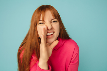 Image showing Caucasian woman\'s portrait isolated on blue studio background with copyspace