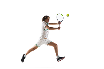 Image showing Young caucasian professional sportsman playing tennis isolated on white background