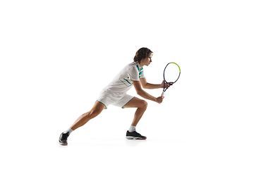 Image showing Young caucasian professional sportsman playing tennis isolated on white background