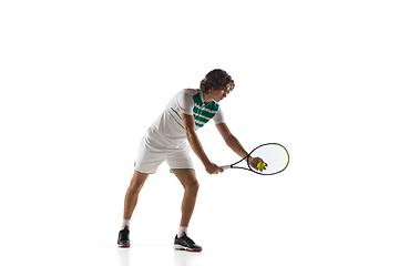 Image showing Young caucasian professional sportsman playing tennis isolated on white background