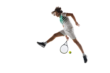 Image showing Young caucasian professional sportsman playing tennis isolated on white background