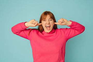 Image showing Caucasian woman\'s portrait isolated on blue studio background with copyspace