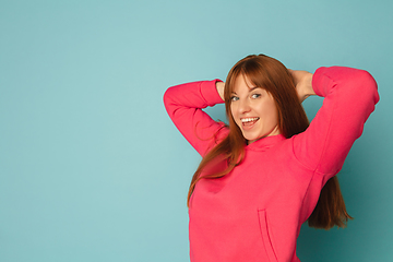 Image showing Caucasian woman\'s portrait isolated on blue studio background with copyspace