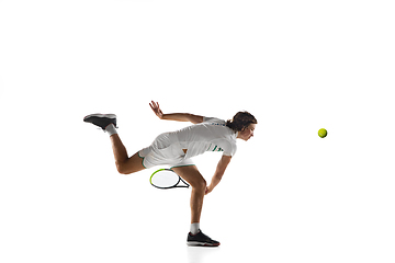 Image showing Young caucasian professional sportsman playing tennis isolated on white background