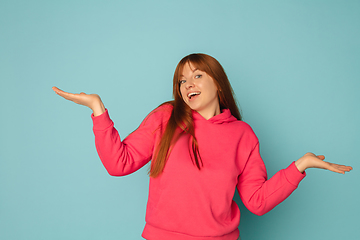 Image showing Caucasian woman\'s portrait isolated on blue studio background with copyspace