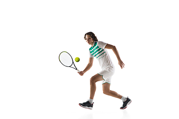 Image showing Young caucasian professional sportsman playing tennis isolated on white background