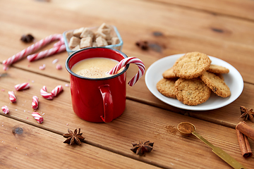 Image showing cup of eggnog with candy cane, cookies and anise