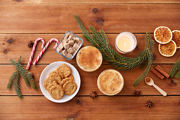 Image showing glasses of eggnog, oatmeal cookies and fir branch