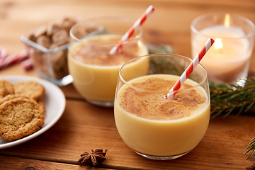 Image showing glasses of eggnog, oatmeal cookies and fir branch