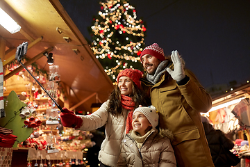 Image showing happy family taking selfie at christmas market