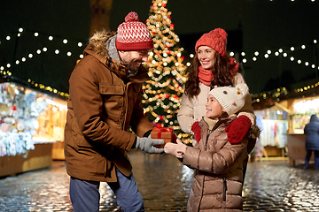 Image showing happy family with gift at christmas market in city