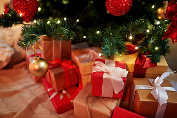 Image showing gift boxes under decorated christmas tree at home