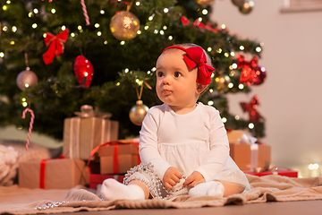 Image showing baby girl at christmas tree with gifts at home