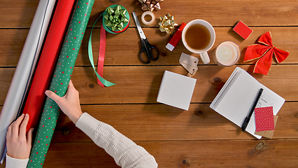 Image showing hands setting stuff for christmas gifts wrapping