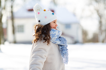 Image showing happy little girl in winter clothes outdoors