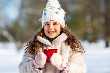 Image showing little girl with cup of hot tea in winter park