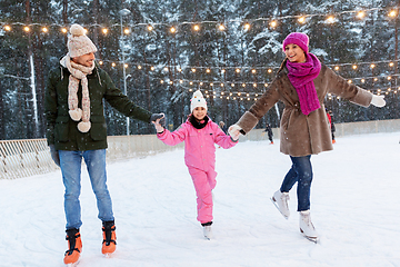 Image showing happy family at outdoor skating rink in winter